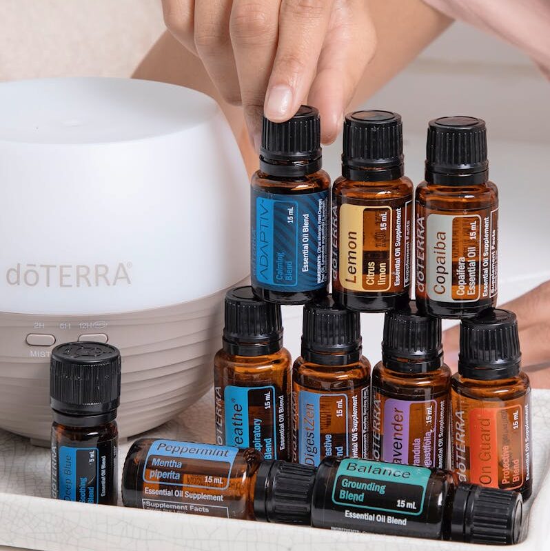 A tray with essential oils, a diffuser, and a towel for a relaxing spa ambiance.